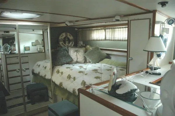 Slide: The Image of 1969 Chris-Craft 47 Commander cabin interior with bed, pillows, and nautical decor. - 24
