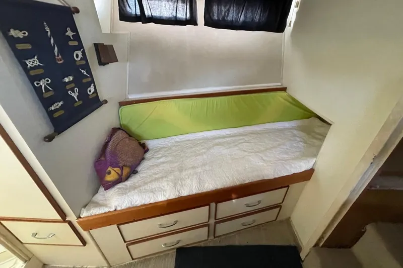 Slide: The Image of Cozy cabin bed with storage in 1969 Chris-Craft 47 Commander yacht interior. - 29