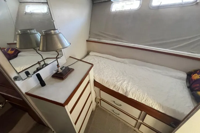 Slide: The Image of 1969 Chris-Craft 47 Commander cabin interior with bed, drawers, and lamp. - 30