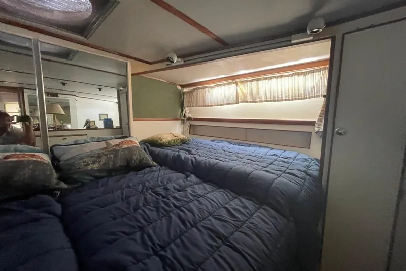 Slide: The Image of Cozy bedroom interior of 1969 Chris-Craft 47 Commander yacht with blue bedding and mirrored closet. - 33