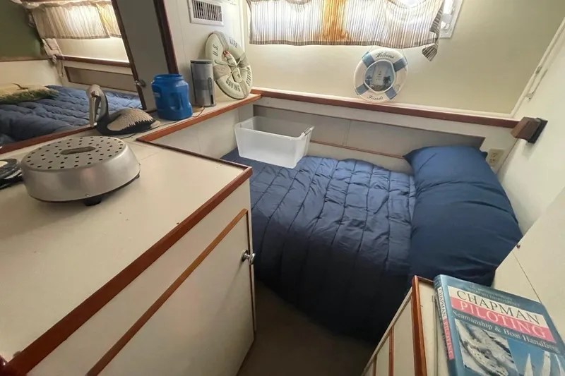 Slide: The Image of Cozy cabin interior of 1969 Chris-Craft 47 Commander with bed and nautical decor. - 35