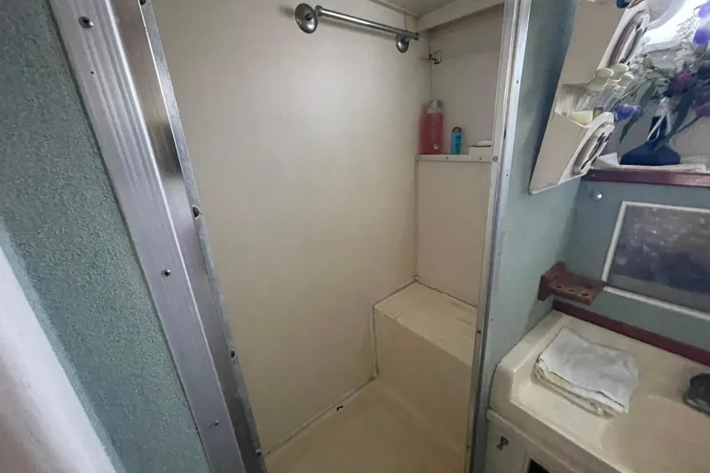 Slide: The Image of Shower area in 1969 Chris-Craft 47 Commander boat, featuring compact design and storage. - 36