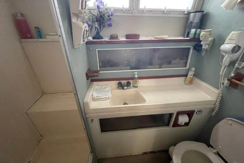 Slide: The Image of Bathroom interior of 1969 Chris-Craft 47 Commander yacht with sink, mirror, and toilet. - 37