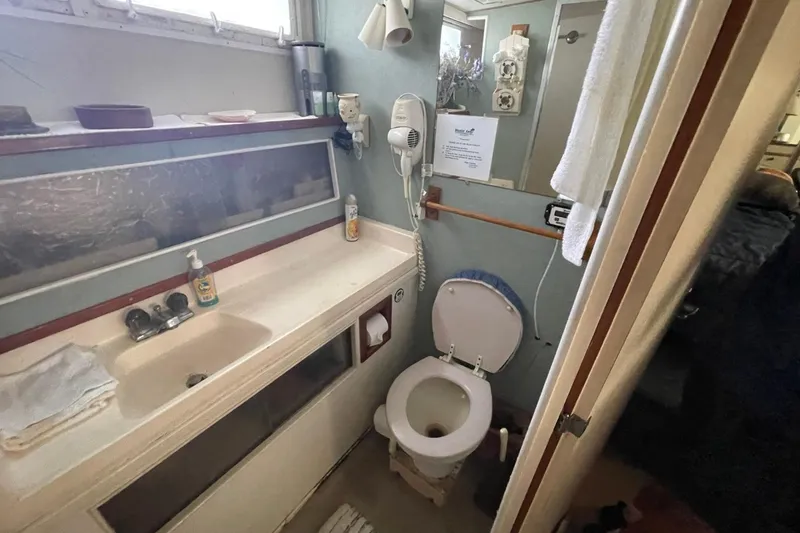 Slide: The Image of Bathroom interior of 1969 Chris-Craft 47 Commander yacht, featuring sink and toilet. - 38