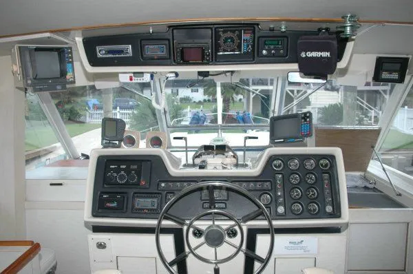 Slide: The Image of 1969 Chris-Craft 47 Commander helm with navigation instruments and steering wheel. - 5