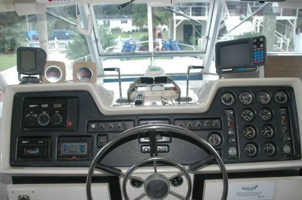 Slide: The Image of Helm of 1969 Chris-Craft 47 Commander with gauges, steering wheel, and navigation equipment. - 6
