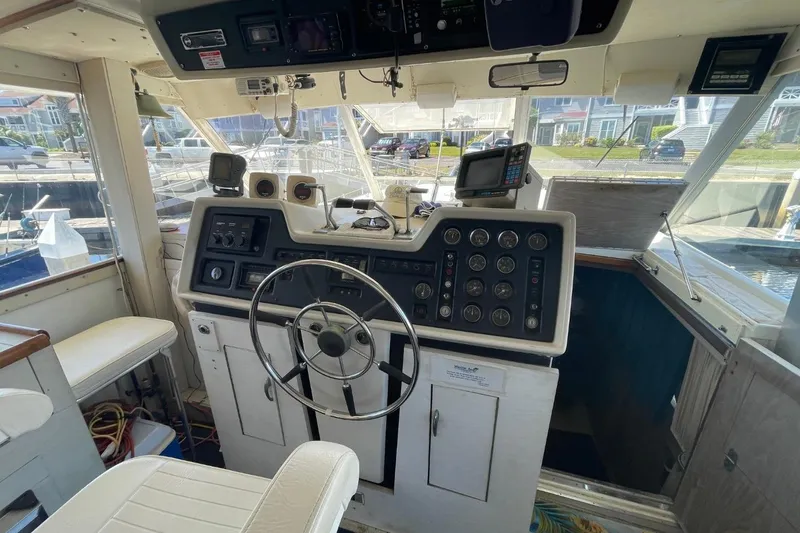 Slide: The Image of 1969 Chris-Craft 47 Commander helm with steering wheel and control panel. - 9