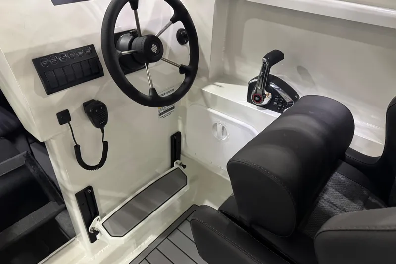 Slide: The Image of Interior of 2026 Extreme Boats 696 Game King, featuring steering wheel and controls. - 13