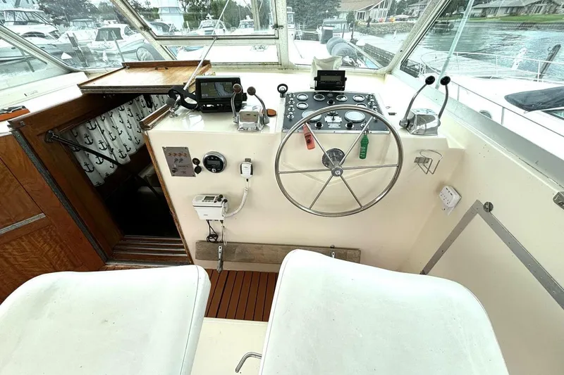 Slide: The Image of 1972 Hatteras 43DC boat helm with steering wheel and control panel. - 21
