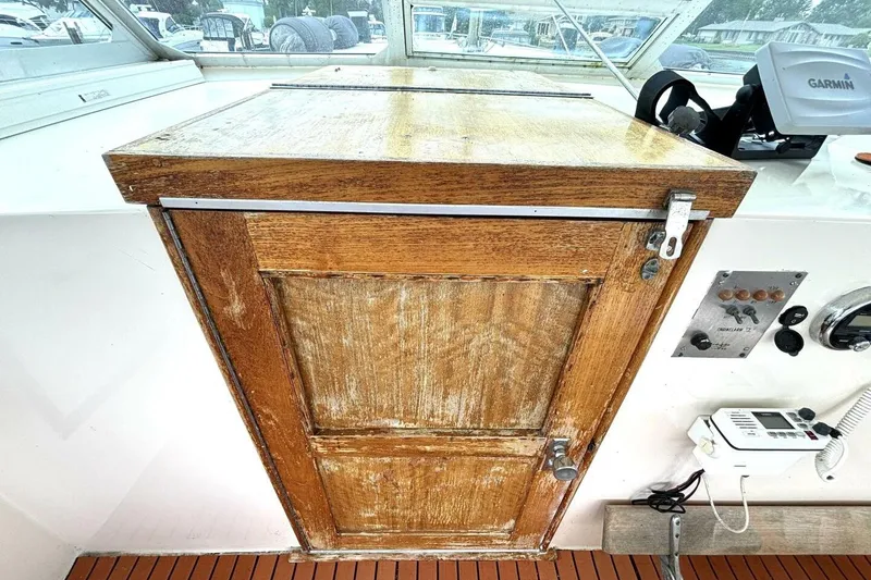 Slide: The Image of 1972 Hatteras 43DC boat interior with wooden cabinet and navigation equipment. - 25