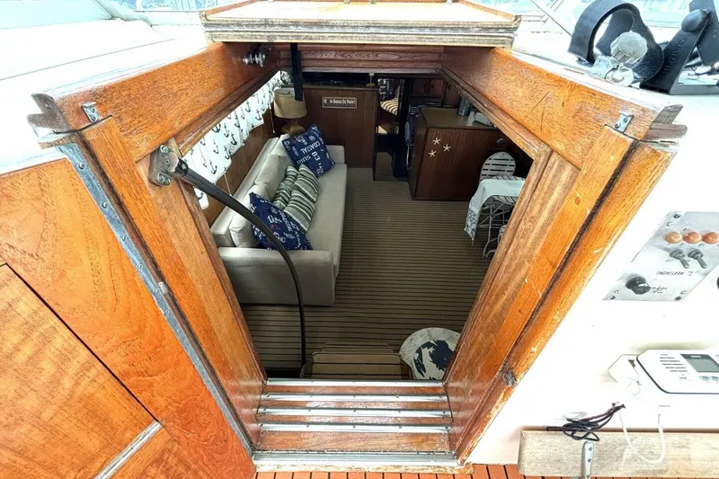 Slide: The Image of Interior view of 1972 Hatteras 43DC yacht, featuring cozy seating and nautical decor. - 26