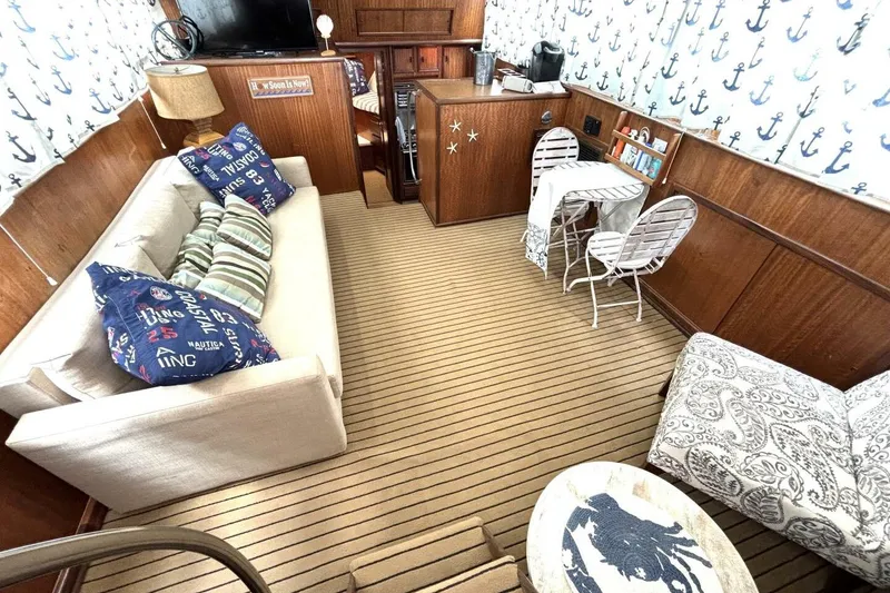 Slide: The Image of Interior of a 1972 Hatteras 43DC yacht with nautical decor and cozy seating. - 27