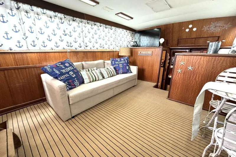 Slide: The Image of Interior of 1972 Hatteras 43DC yacht with nautical decor and cozy seating area. - 28
