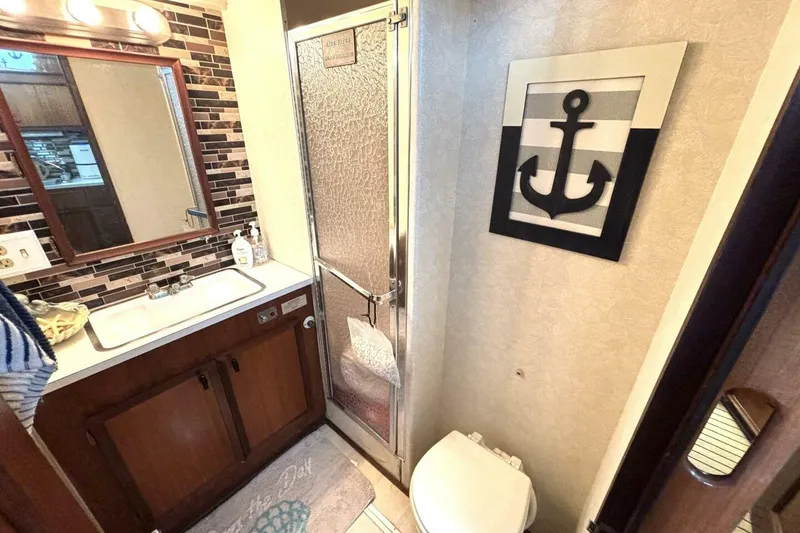 Slide: The Image of Bathroom interior of 1972 Hatteras 43DC yacht with anchor decor and modern fixtures. - 36