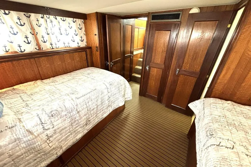 Slide: The Image of Interior of 1972 Hatteras 43DC yacht with twin beds, nautical decor, and wood paneling. - 39