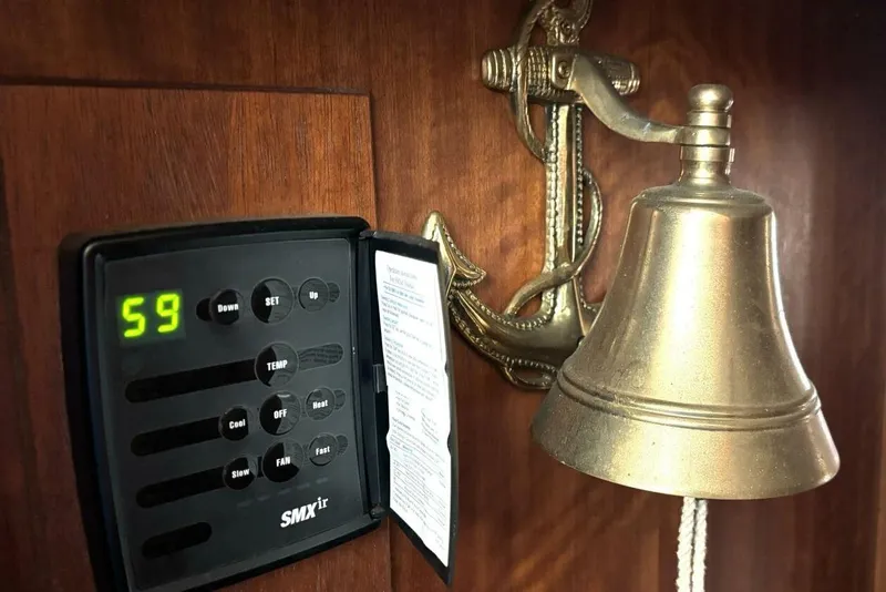 Slide: The Image of 1972 Hatteras 43DC interior with brass bell and digital control panel. - 42