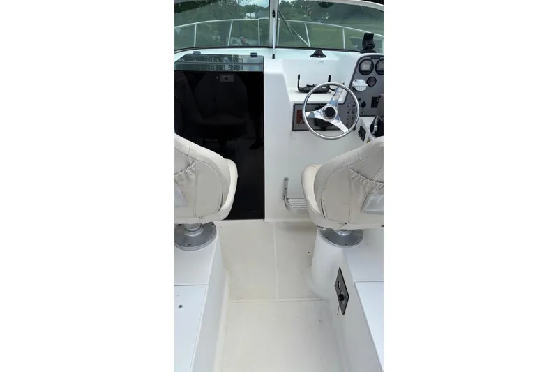 Slide: The Image of Interior view of 2002 Wellcraft 24 Walkaround boat cockpit with steering wheel and seats. - 5