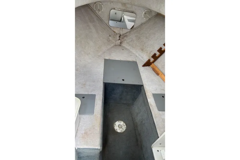 Slide: The Image of Interior cabin of 2002 Wellcraft 24 Walkaround boat, featuring storage compartments and seating. - 8