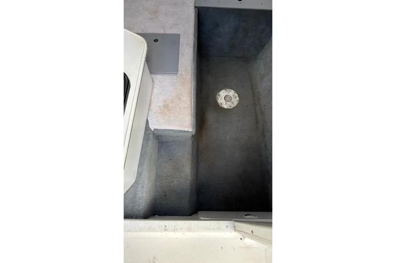 Slide: The Image of Interior view of a 2002 Wellcraft 24 Walkaround boat, showcasing storage compartment. - 9