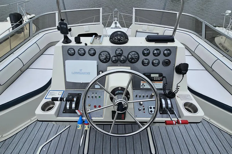 Slide: The Image of 1990 Carver 3467 Santego yacht helm with steering wheel and control panel. - 14