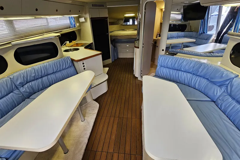 Slide: The Image of Interior of 1990 Carver 3467 Santego yacht with blue seating and wooden flooring. - 18