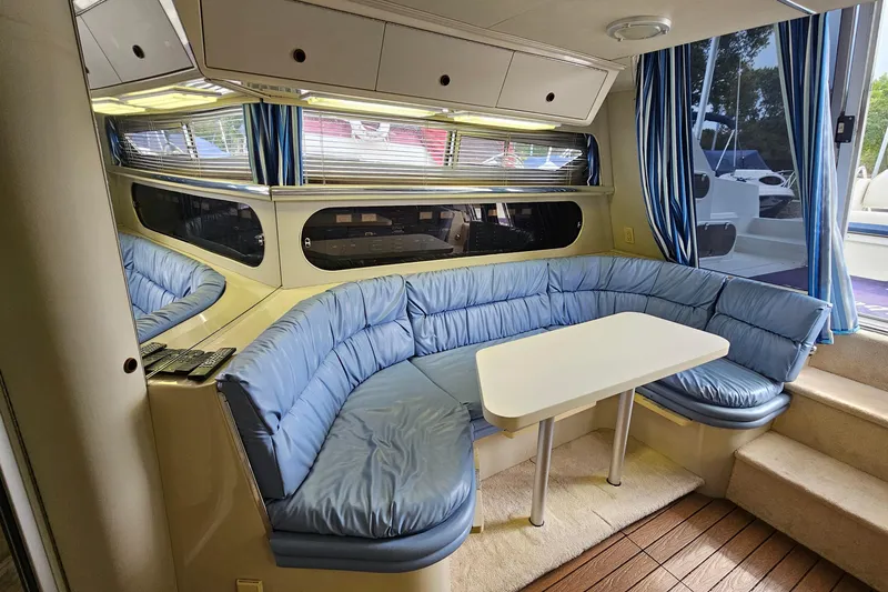 Slide: The Image of Interior of 1990 Carver 3467 Santego yacht with blue seating and white table. - 20