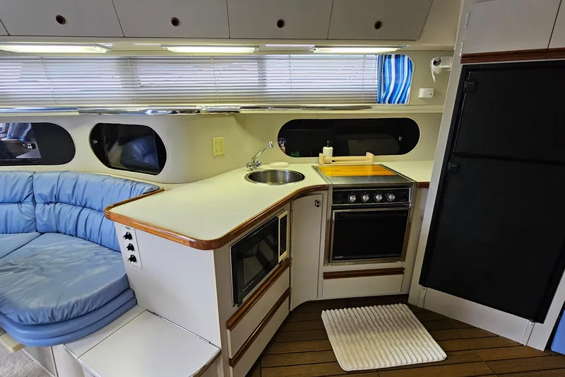 Slide: The Image of Interior of 1990 Carver 3467 Santego yacht with kitchen and seating area. - 22