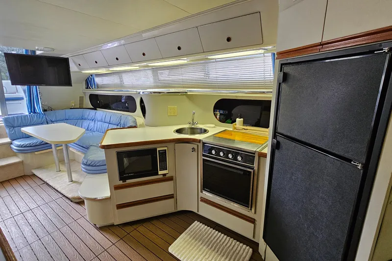 Slide: The Image of Interior of a 1990 Carver 3467 Santego yacht with kitchen and seating area. - 23
