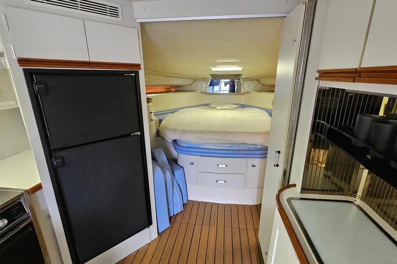 Slide: The Image of Interior of 1990 Carver 3467 Santego yacht with cozy bedroom and kitchenette. - 25