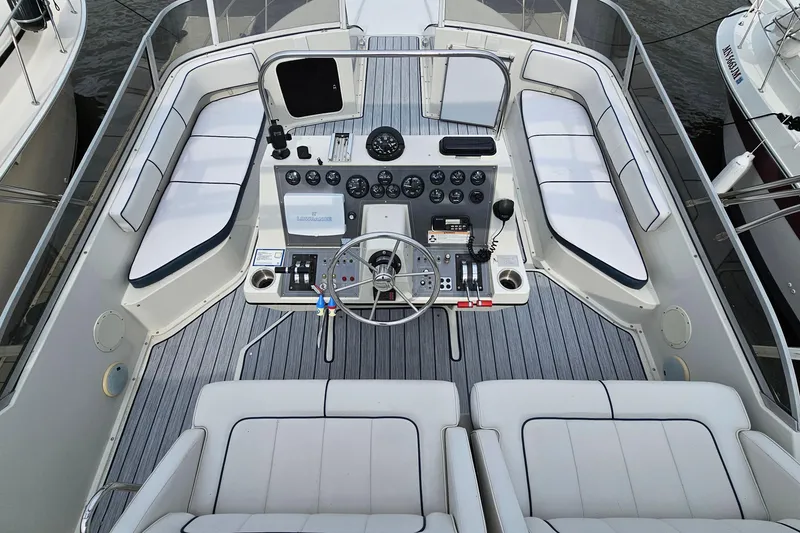 Slide: The Image of 1990 Carver 3467 Santego yacht cockpit with helm, seating, and control panel. - 9