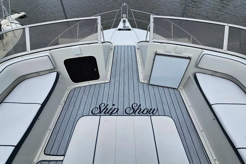 Slide: The Image of 1990 Carver 3467 Santego boat deck with "Ship Show" text, featuring cushioned seating. - 10