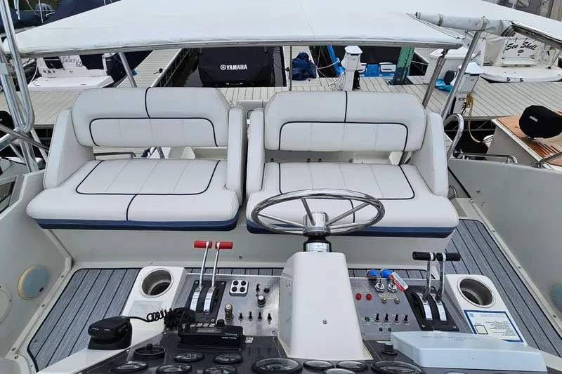 Slide: The Image of 1990 Carver 3467 Santego yacht helm with dual seating and control panel. - 11