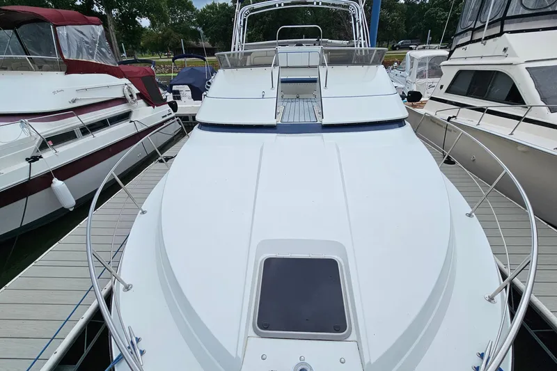 Slide: The Image of 1990 Carver 3467 Santego yacht docked among other boats at a marina. - 17