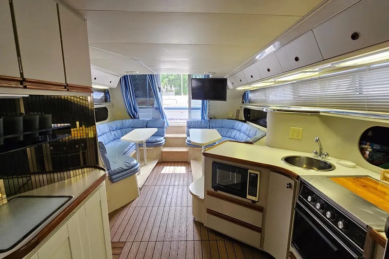 Slide: The Image of Interior of 1990 Carver 3467 Santego yacht with kitchen and seating area. - 19