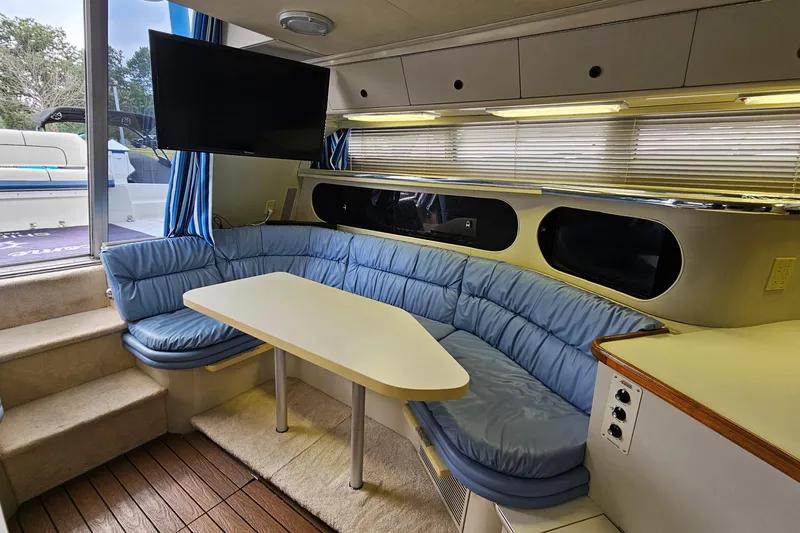 Slide: The Image of Interior of 1990 Carver 3467 Santego yacht with blue seating and a mounted TV. - 21