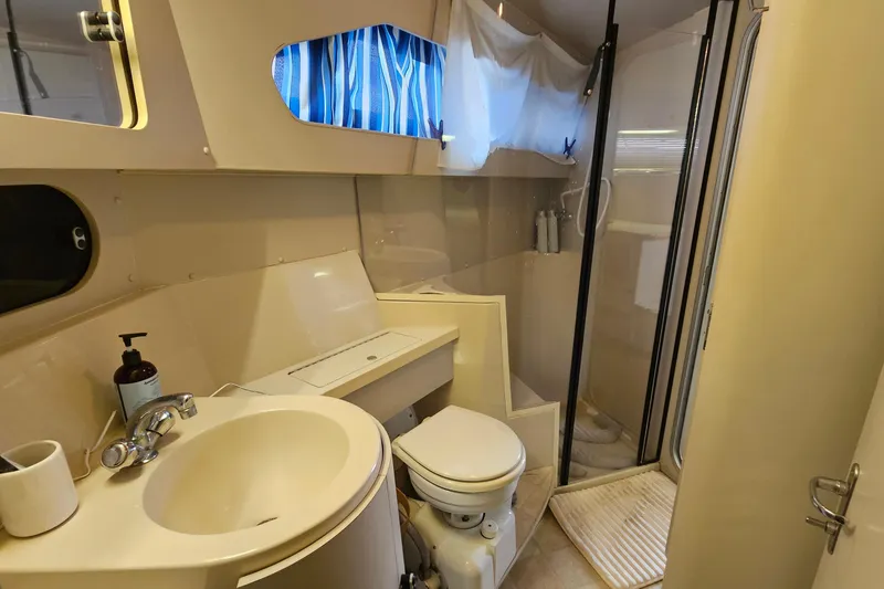 Slide: The Image of 1990 Carver 3467 Santego yacht bathroom with sink, toilet, and shower. - 27