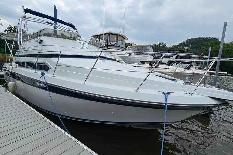 Slide: The Image of 1990 Carver 3467 Santego yacht docked at marina, featuring sleek design and spacious deck. - 4