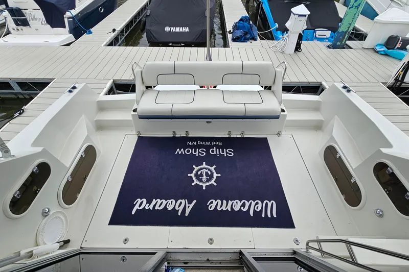 Slide: The Image of 1990 Carver 3467 Santego yacht interior with welcome mat and seating at dock. - 6