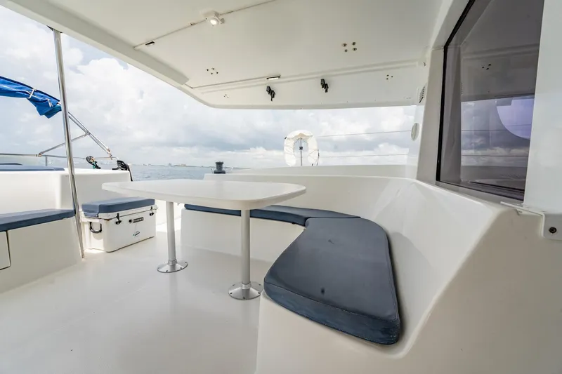 Slide: The Image of 2008 Fountaine Pajot Salina 48 Evolution yacht with outdoor seating and table, ocean view. - 42