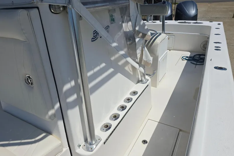 Slide: The Image of 2007 Competition 31 boat on trailer with Yamaha outboard motor, parked outside a warehouse. - 11