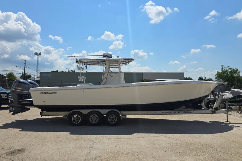 Slide: The Image of 2007 Competition 31 boat with rod holders and steering console, docked outdoors. - 2