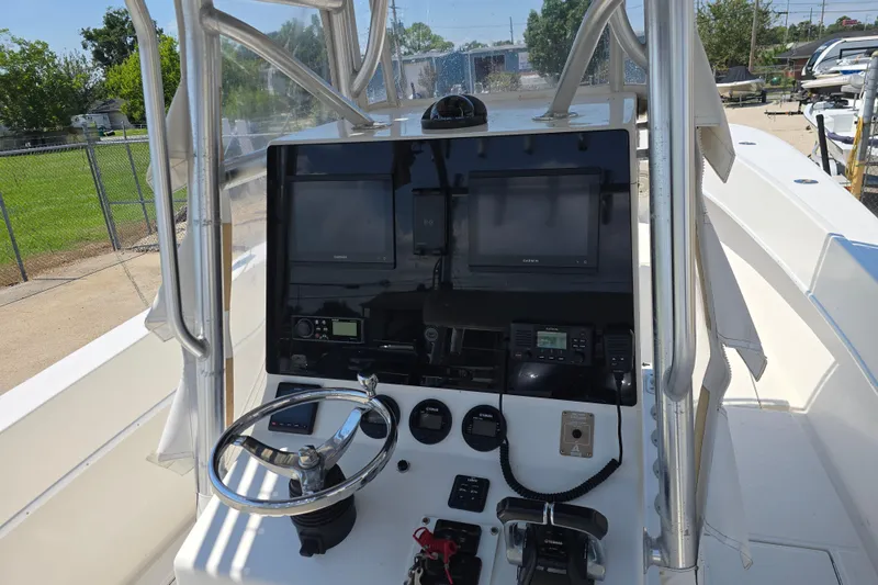 Slide: The Image of Center console of a 2007 Competition 31 boat with navigation equipment and steering wheel. - 24