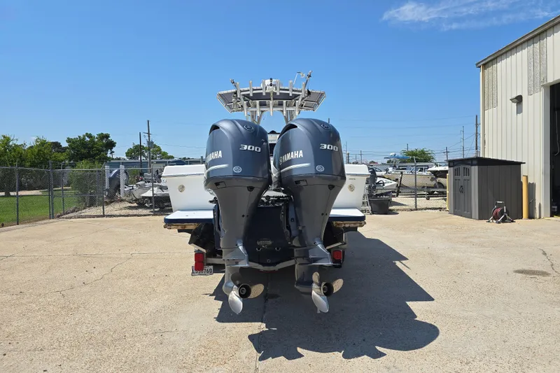 Slide: The Image of 2007 Competition 31 boat with center console and fishing rod holders, parked on a trailer. - 4