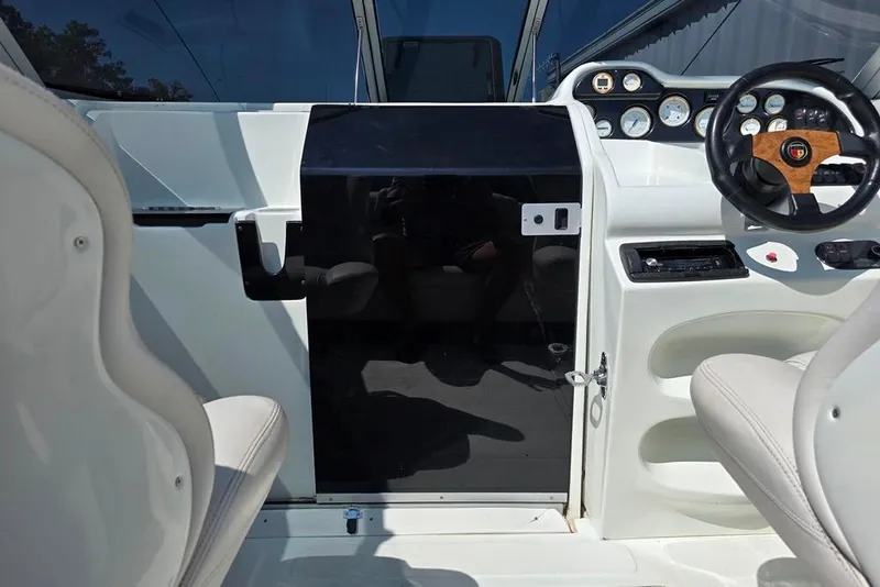Slide: The Image of 1999 Mariah Shabah Z250 Cuddy Cabin interior with steering wheel and dashboard controls. - 6