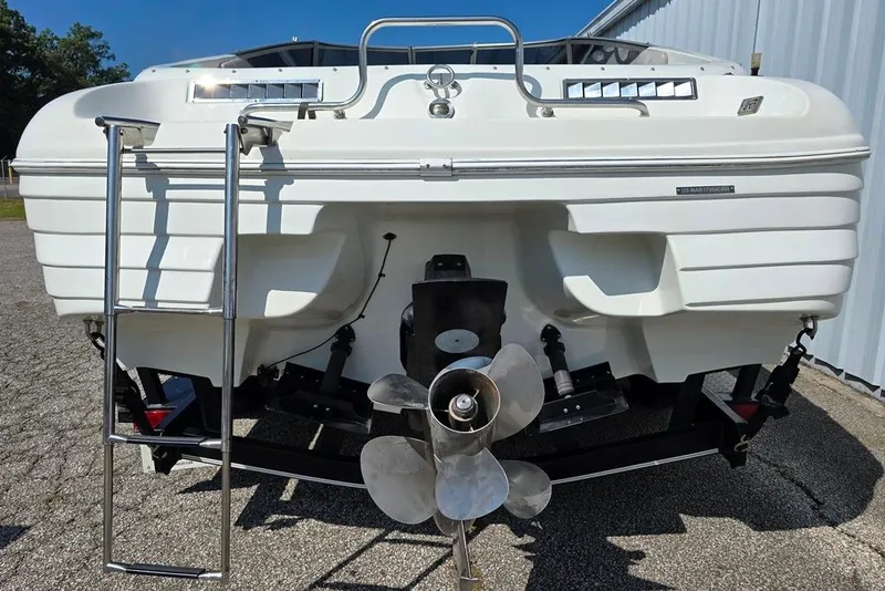 Slide: The Image of 1999 Mariah Shabah Z250 Cuddy Cabin boat rear view with propeller and ladder. - 11