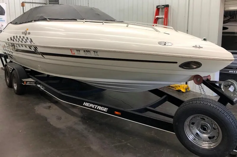 Slide: The Image of 1999 Mariah Shabah Z250 Cuddy Cabin boat on trailer in garage setting. - 17