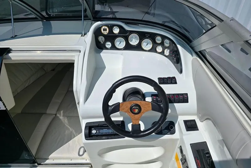 Slide: The Image of 1999 Mariah Shabah Z250 Cuddy Cabin dashboard with steering wheel and gauges. - 18