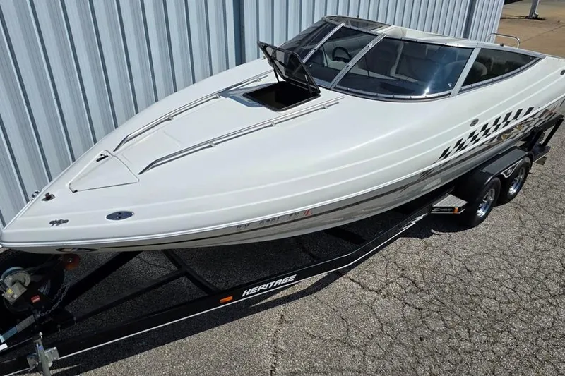 Slide: The Image of 1999 Mariah Shabah Z250 Cuddy Cabin boat on trailer, parked outdoors. - 2