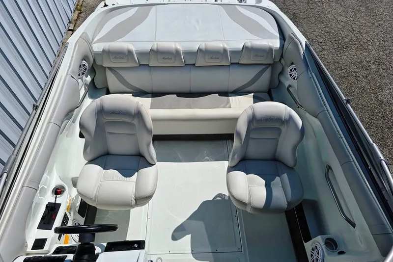 Slide: The Image of 1999 Mariah Shabah Z250 Cuddy Cabin interior with white leather seating and steering wheel. - 4