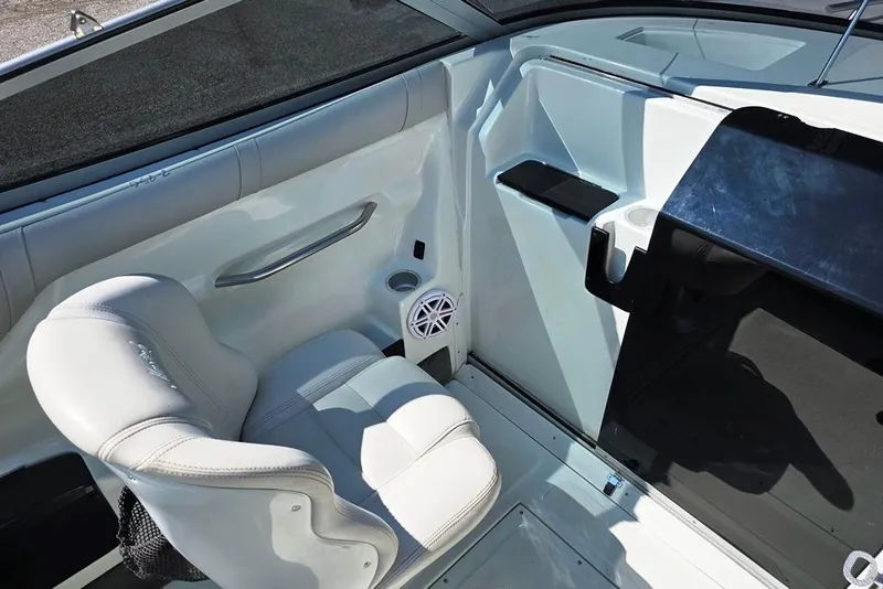 Slide: The Image of Interior of 1999 Mariah Shabah Z250 Cuddy Cabin boat with white seating and speaker. - 5